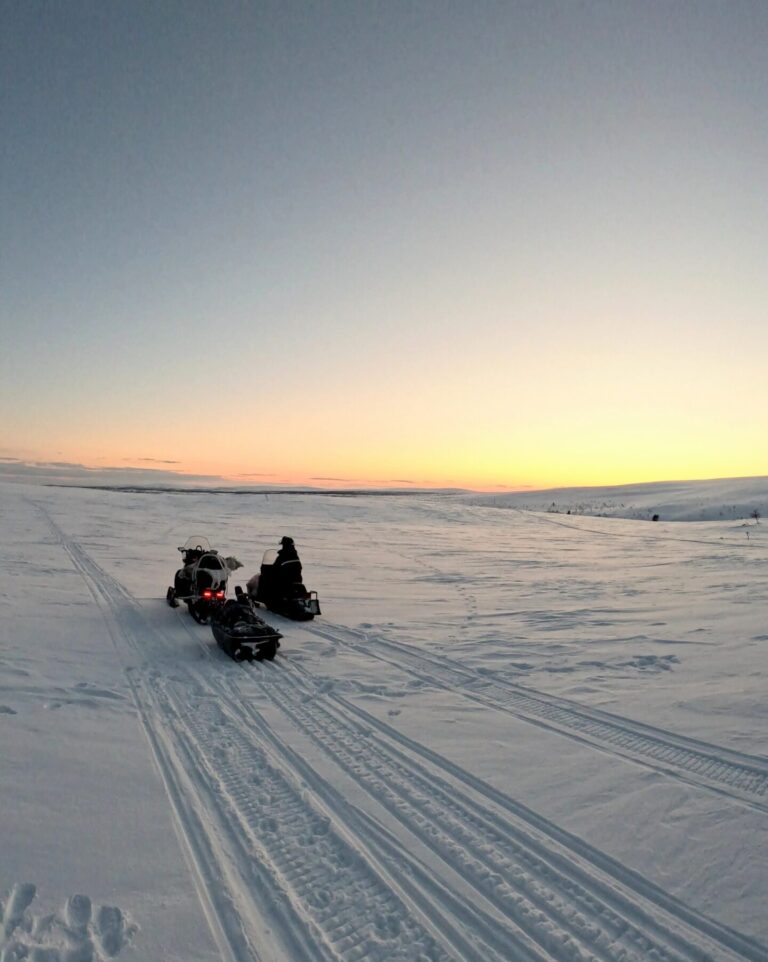 Two snowmobiles in the wilderness in Enontekiö Lapland during snowmobile safari.