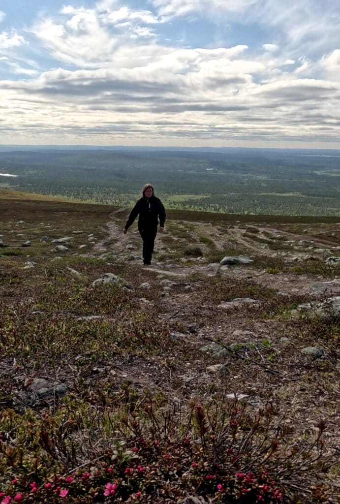 A woman walking on the open tundra in Lapland.