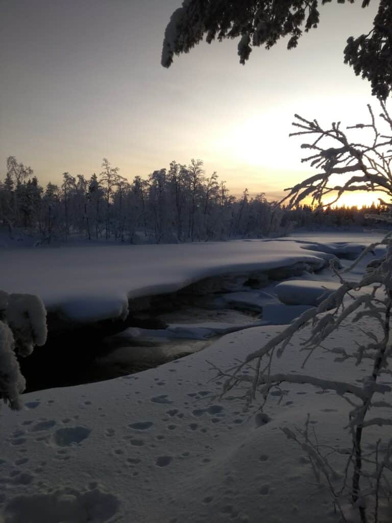 Open river in the middle of winter during snowshoeing tour in Hetta Enontekiö Lapland.